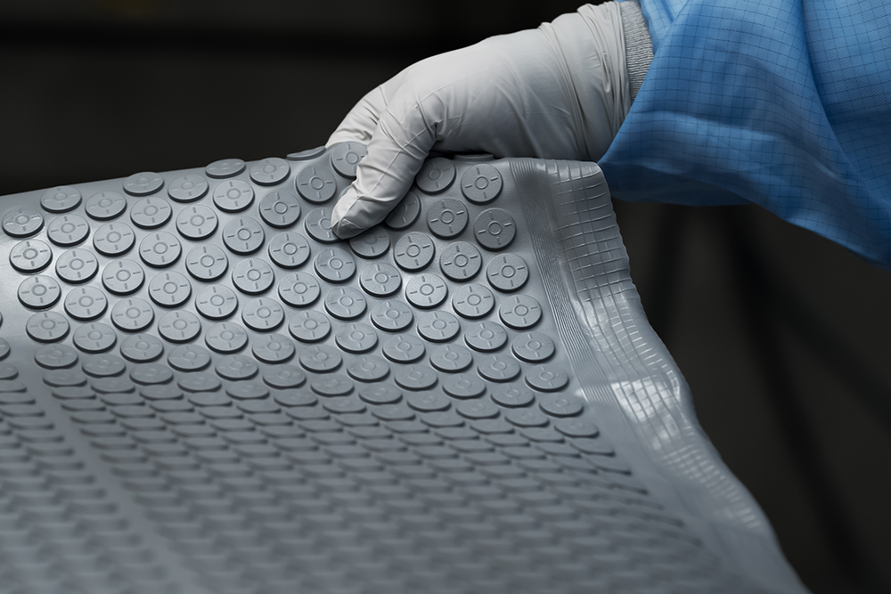 Aptar Pharma vial rubber stopper being manufactured in a clean room to limit the risk of particulate and biological contamination.