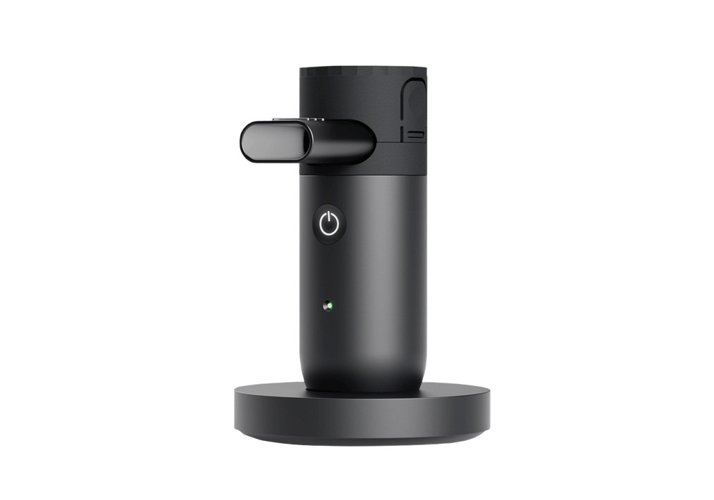 Single black cylindrical Kolibri mesh nebulizer (NPLI) on charging mount with digital data connectivity by Aptar.