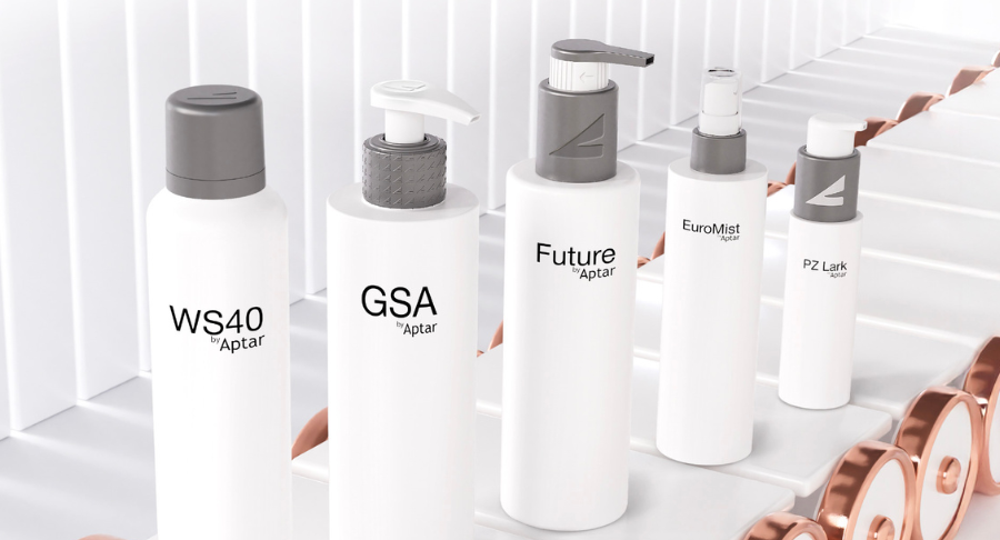 Five white packaging with logo and pattern branding on grey matte dispensing systems standing on a conveyor belt on a white background